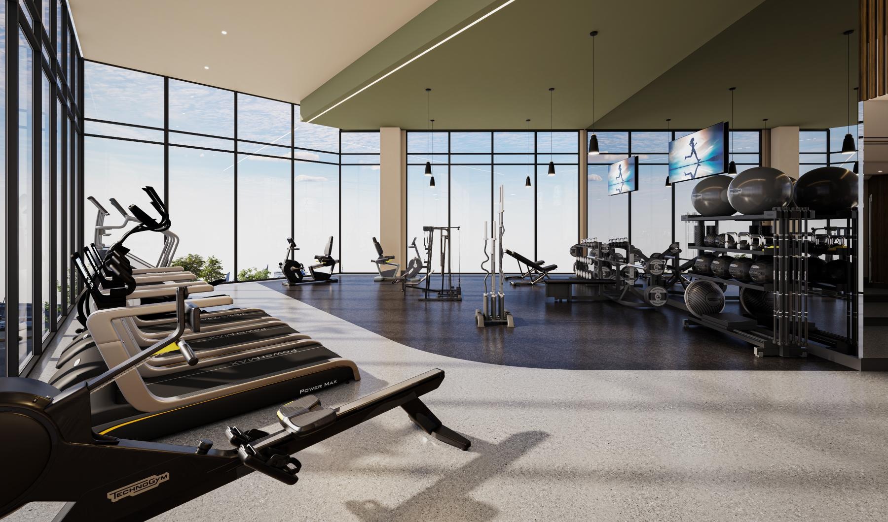a room with exercise equipment and windows