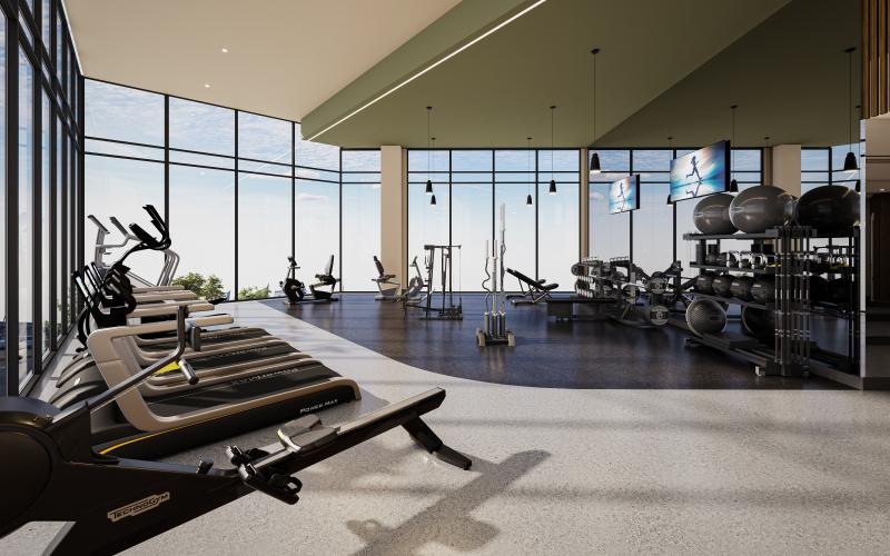 a room with exercise equipment and windows